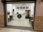 Take Away At Entrance Of Busy Mall For