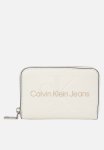 Calvin Klein Scuplted Medium Zip Around Purse - Cream